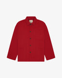 Front flat shot of berry red, buttoned organic cotton overshirt. Clear view of chest and hip pockets, corozo buttons and simple, boxy shape.