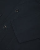 View of the mid-section and sleeve of the 3001 Uskees button-down drill overshirt in dark blue (blueberry) with focus on cuff, placket and hip pocket.