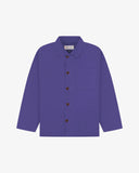 Front flat shot of purple, buttoned organic cotton overshirt. Clear view of chest and hip pockets, corozo buttons and simple, boxy shape.
