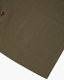 Closer view bottom-right section of dark taupe, buttoned organic cotton overshirt from Uskees. Focus on cuff, pockets and corozo buttons.