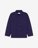Front flat shot of deep indigo, buttoned organic cotton overshirt. Clear view of chest and hip pockets, corozo buttons and simple, boxy shape.