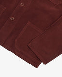 View of the hem, sleeve and hip pocket of the 3001 Uskees button-down corduroy overshirt in deep wine berry.