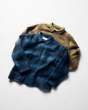 Angled and ruffled flat shot of woodland green check Delph and peacock blue check Tame wool overshirts.