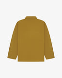 Back view of mustard-yellow, buttoned organic cotton overshirt with view of reinforced elbow area and boxy silhouette.
