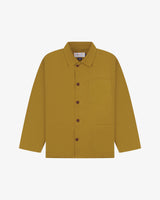 Front flat shot of mustard-yellow, buttoned organic cotton overshirt. Clear view of chest and hip pockets, corozo buttons and simple, boxy shape.