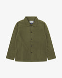 Front flat shot of olive green, buttoned ripstop overshirt. Clear view of chest and hip pockets, corozo buttons and Uskees branding label.