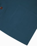 View of the hem and hip pocket of the 3001 Uskees button-down organic cotton overshirt in maya blue.