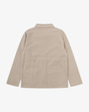 Reverse of oatmeal (beige) buttoned organic cotton drill overshirt from Uskees. Showing reinforced elbows and boxy silhouette.