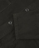 Closer view of mid section of green-brown (seaweed), buttoned corduroy overshirt from Uskees. Focus on cuff, pockets, corozo buttons and corduroy texture.