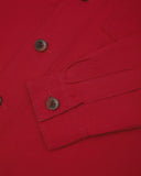 View of the mid-section and sleeve of the 3003 Uskees button-down work shirt in berry red with focus on cuff, placket and corozo buttons.