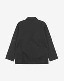 Reverse of black buttoned organic cotton-twill blazer from Uskees showing reinforced elbows and boxy silhouette.