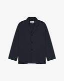 Dark blue (blueberry) buttoned organic cotton-drill blazer from Uskees with clear view of three patch pockets and Uskees branding label.