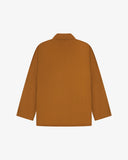 Reverse of buckthorn (mustard yellow) buttoned organic cotton-drill blazer from Uskees showing reinforced elbows and boxy silhouette.