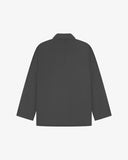 Reverse of charcoal-grey buttoned organic cotton-drill blazer from Uskees showing reinforced elbows and boxy silhouette.