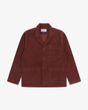 Full front view of deep wine berry coloured buttoned organic corduroy blazer from Uskees with notch lapels, a three-button front closure, three patch pockets and Uskees branding label.