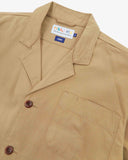 Angled top-half view of #3006, khaki organic cotton-twill blazer. With focus on collar, lapels, breast pocket, Uskees brand label and corozo buttons.