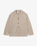 Full front view of oatmeal (beige) buttoned organic cotton-drill blazer from Uskees with notch lapels, a three-button front closure, three patch pockets and Uskees branding label.