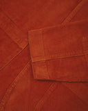 Close-up view of cuff, placket and corozo buttons of rust-red blazer from Uskees and providing a clearer view of the 11 wale organic corduroy.