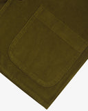 Close-up view of hem, hip patch pocket and texture of 11 wale organic corduroy, woodland green blazer from Uskees.