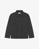 Front view of Uskees charcoal-grey drill field jacket showing the chest zip pockets and gusseted pockets with flaps.