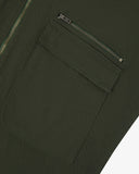 Close up view of Uskees vine green drill field jacket with focus on a zip and gusseted chest pocket.