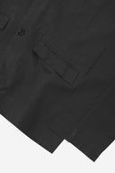 Close-up view of the cuff, jetted hip pocket and corozo buttons of the 3047 docklands blazer from Uskees. Also is a closer view of the texture of the black organic cotton twill . 