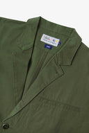 Close-up and angled front view of the 3047 docklands blazer showing the twill fabric texture, collar, lapel, Uskees branding label and jetted breast pocket.