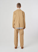 Back view of male model wearing the Uskees 3047 Docklands khaki blazer with view of back vent.