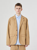 Three-quarter pose of man wearing the Uskees 3047 Docklands khaki blazer, paired with blue shirt.