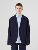 Three-quarter pose of man wearing the Uskees 3047 Docklands midnight blue blazer, paired with blue shirt.