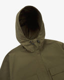 Front view of Uskees army green Evo shell coat with focus on hood and toggles.