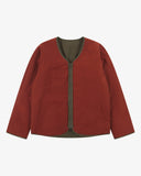 Front view of Uskees Evo liner jacket reversed showing the orange-red reversable lining and the chest and twin wax welt pockets.