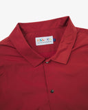 Close up flat shot of Uskees clay red coach jacket for men with focus on collar, contrast inner yoke, Uskees brand label and popper buttons.