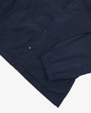 Close up shot of Uskees navy blue coach jacket for men showing the elasticated cuff and black poppers.
