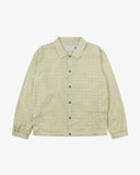 Front flat shot of Uskees pastel yellow check coach jacket for men showing sharp, contemporary detailing including slanted welt pockets, cinch hem and popper fastening.