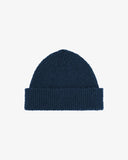 Front view of Uskees 4003 'shadow marine' dark blue Donegal wool hat with light blue speckles and showing the adjustable cuff.