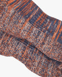 Closer view of the foot and heel portion of the Uskees 4006 volcanic orange organic cotton sock, showing bands of gold-orange, violet and beige.
