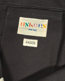 Close-up inside view of Uskees 4009 canvas tote bag in charcoal-grey with focus on the internal patch pocket and branding logo.