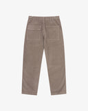 Back view of Uskees brown corduroy pants showing the belt loops and back pockets on a white background.