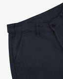 Close up of waist area of drill workwear pants in blueberry. Clear view of front pocket, Corozo button fastening, and organic cotton drill weave.