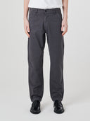 Close-up front view of model wearing Uskees twill workwear pants in charcoal-grey.