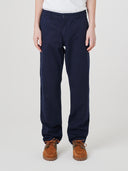 Close-up front view of model wearing Uskees twill workwear pants in deep blue.