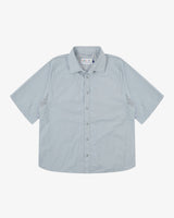 Front flat shot of Uskees pale blue-grey short-sleeve Technique trekking shirt for men indicating relaxed fit.
