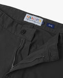 Close-up front view of the front zipper, belt loops and Corozo button fastening the of charcoal grey twill pants.