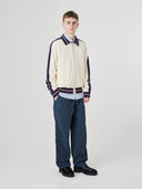 Full-length view of model wearing 5020 drill utility pants in blueberry. Indicating tapered fit on the leg, deep front pockets and reinforced knee patches. 