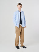 Full-length view of model wearing 5020 ripstop utility pants in khaki, paired with Uskees shirt.