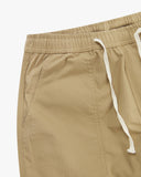 Close up front view of the front pocket, elasticated waist and tie of the khaki ripstop pants from Uskees.