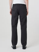 Close-up back view modelling 5021 Uskees men's organic twill black painter pants highlighting back patch pockets and gradual, narrowing leg.