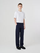 Full-length view modelling 5021 Uskees men's organic twill midnight blue painter pants paired with Uskees plain white t-shirt.