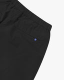Close up back view of the jetted back pocket, elasticated waist and small Uskees tab label of the black ripstop shorts.